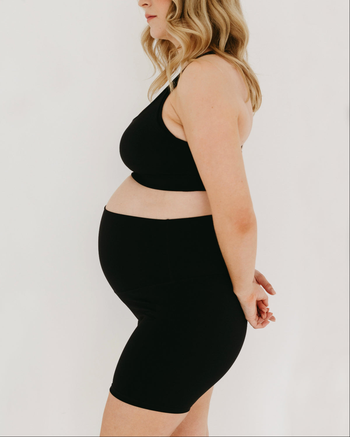 Black AXK high-impact, racerback, maternity and nursing sports bra with one-handed clip access. Premium maternity athletic and activewear by AXK, offered in plus size maternity, tall friendly, and petite maternity sizing.