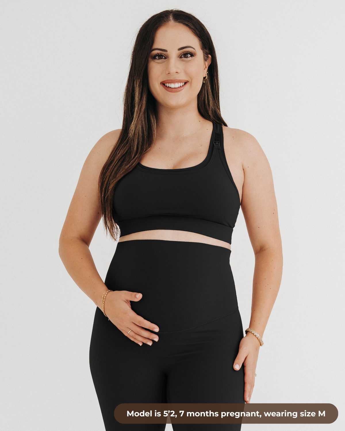 Pregnant woman wearing a black high-impact, racerback, maternity and nursing sports bra with one-handed clip access. 2026 premium best selling maternity athletic and activewear by AXK, petite and tall friendly, standard and plus sizes.