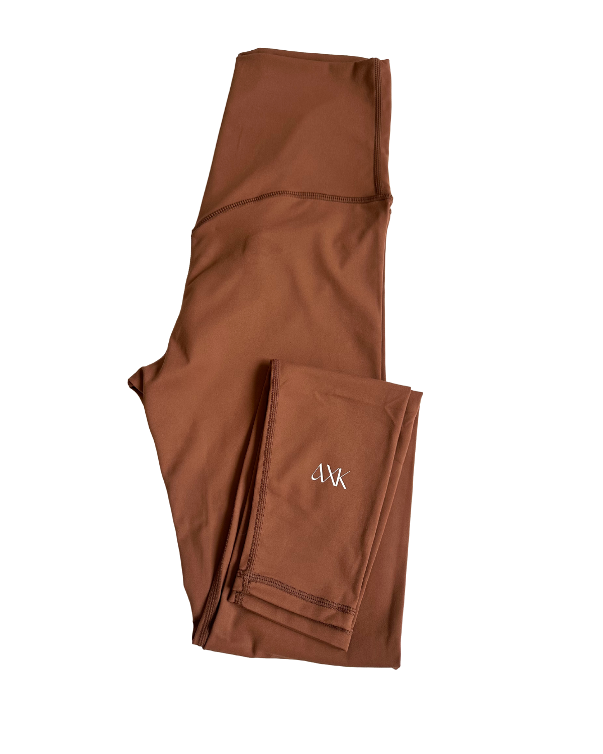 Flat lay of premium brown maternity leggings with a supportive high waist and V-seam back detail, featuring the AXK logo on the ankle, displayed on a white background. Premium maternity athletic and activewear by AXK.