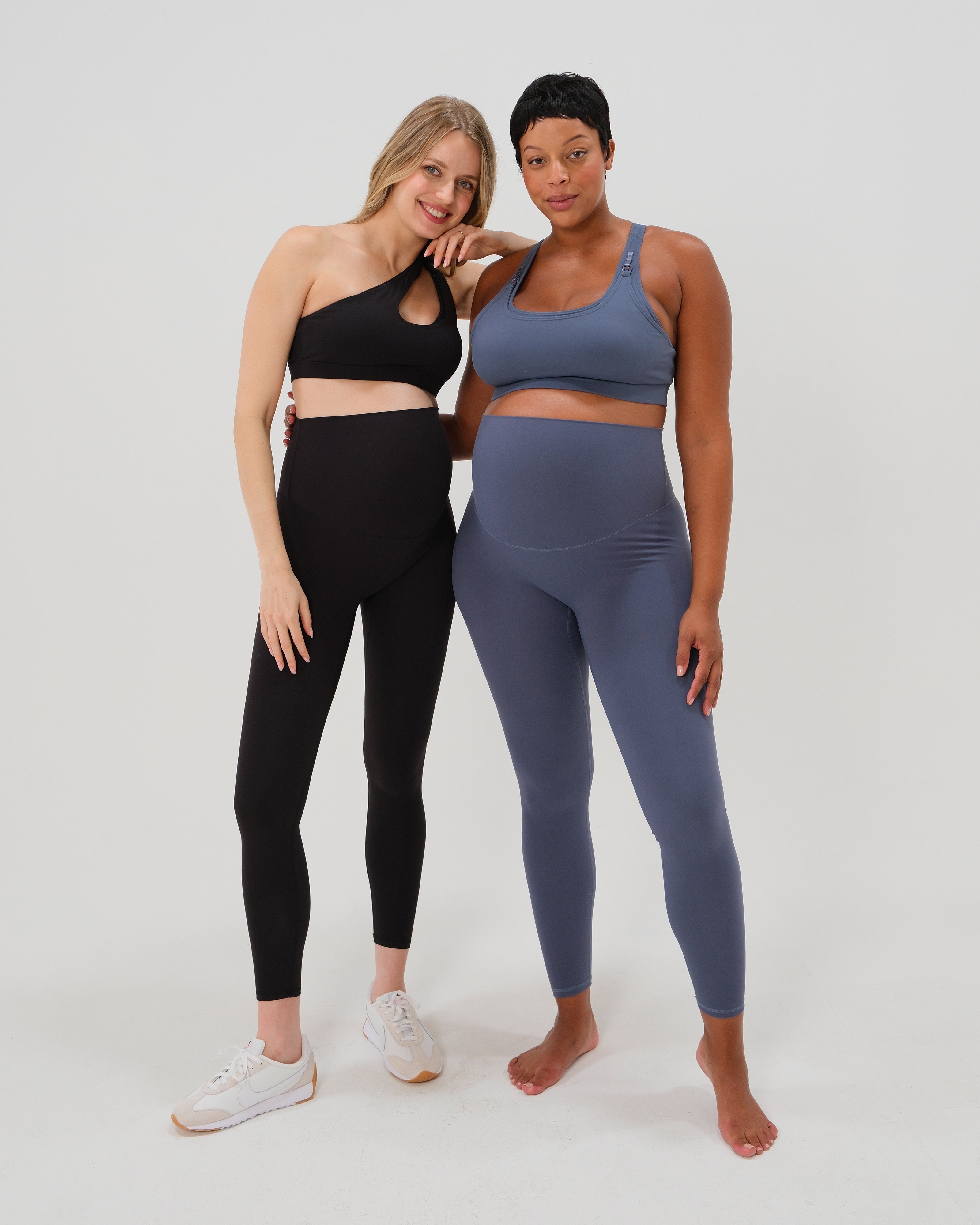 Plus size and thin pregnant women wearing our best reviewed AXK premium black and blue maternity leggings for 2026 with a matching trendy one shoulder nursing sports bras. Premium maternity athletic and activewear by AXK, available in plus sizes. Petite and tall friendly. 
