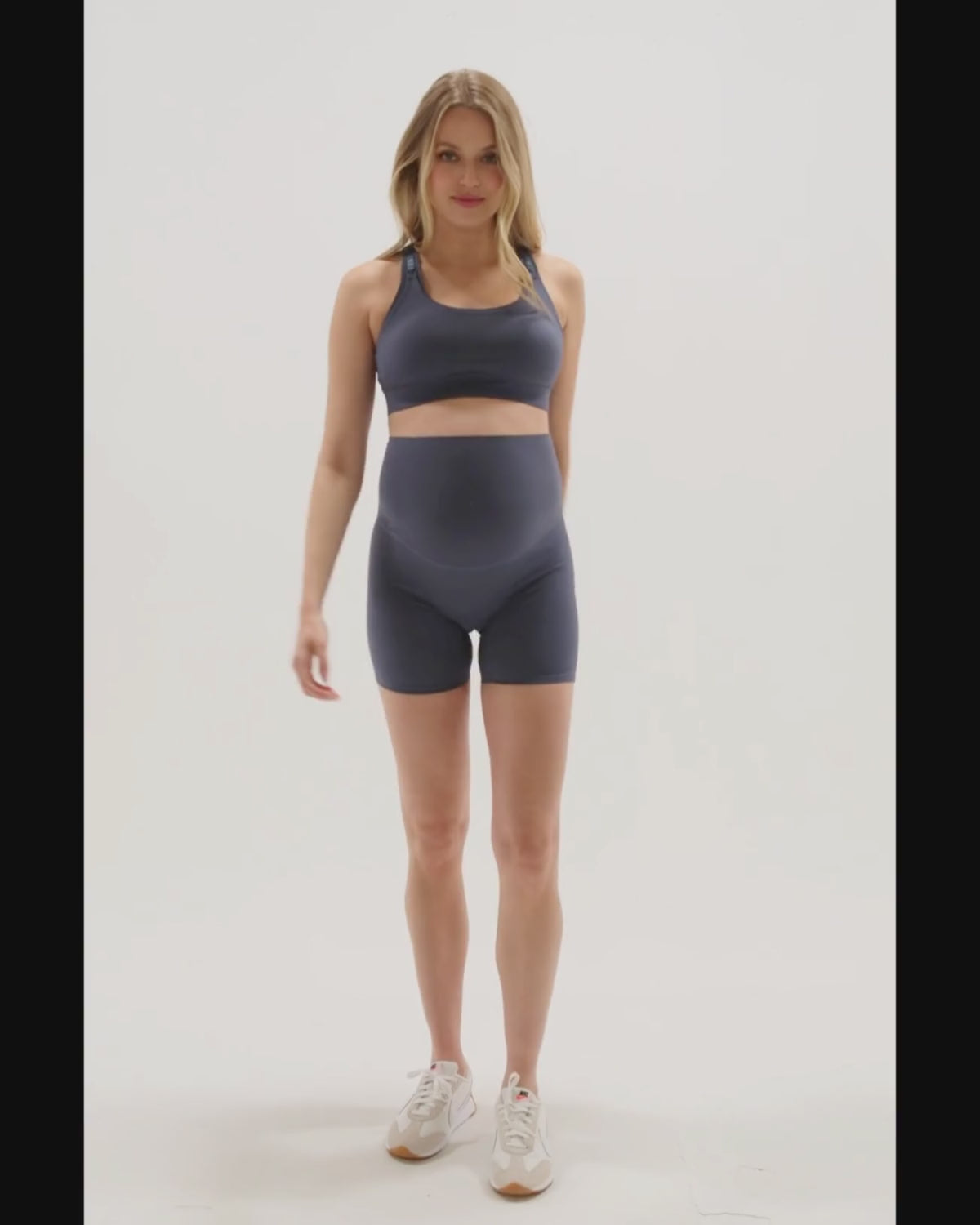 Video of a beautiful pregnant woman wearing premium blue maternity bike shorts with a supportive high waist and matching high-impact, racerback nursing sports bra. Our top reviewed maternity athletic and activewear by AXK is truly the best on the market in 2026, is petite friendly, and is available in regular and plus sizes. 